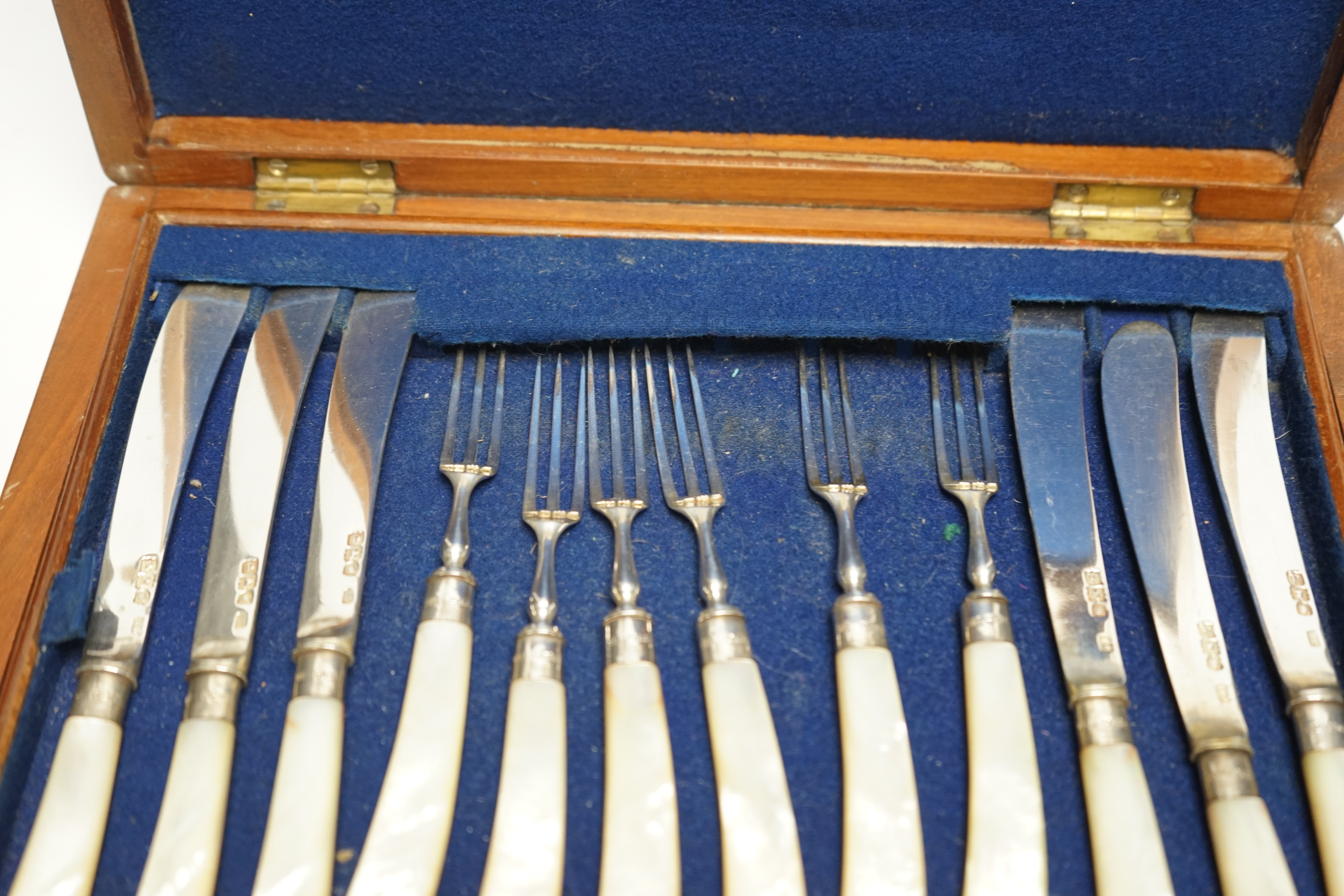 A set of twelve pairs of late Victorian mother of pearl pistol handled silver dessert eaters, by Levesley Brothers, London, 1899, in associated case. Condition - poor
